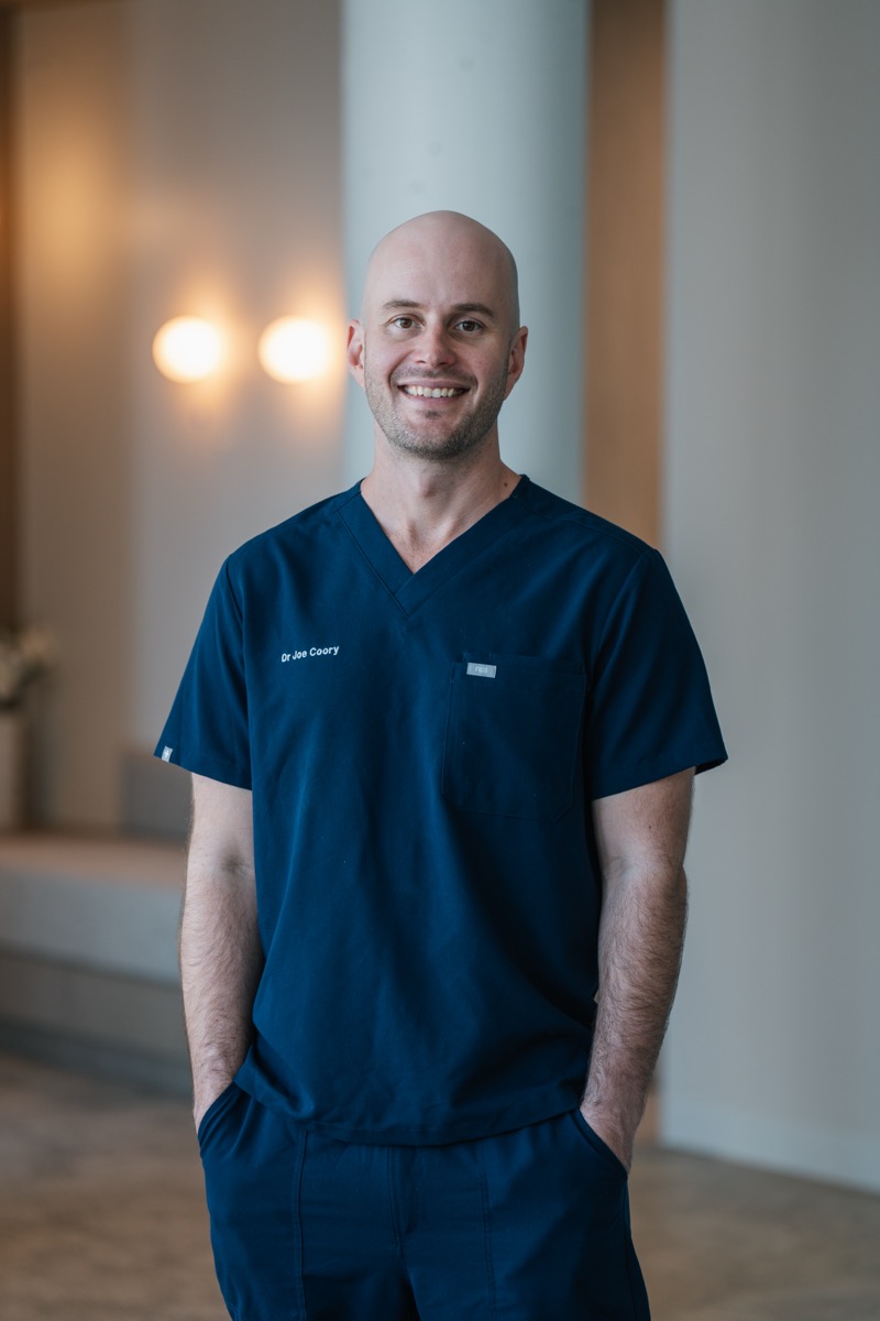 Dr Joe Coory in surgical scrubs in the hospital corridor