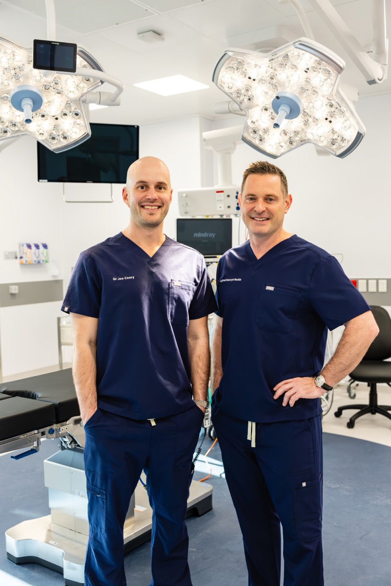 Dr Coory and colleagues in surgical scrubs in the operating theatre